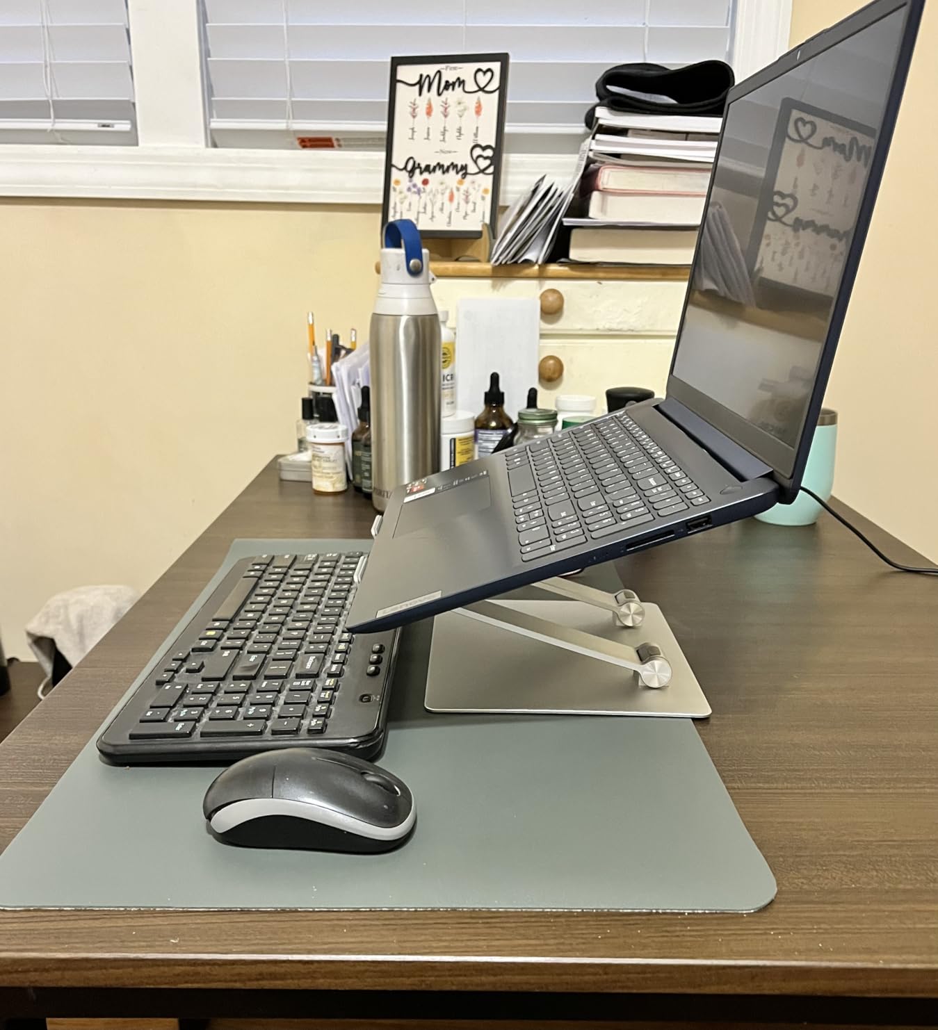 Amazon Basics Sturdy and Portable Ergonomic Laptop Stand for Desk, Height Adjustable Riser with Ventilated Cooling, Foldable, Fits all Laptops up to 17.3 Inch, Silver, 10 x 8.7 x 6 in customer photo 1